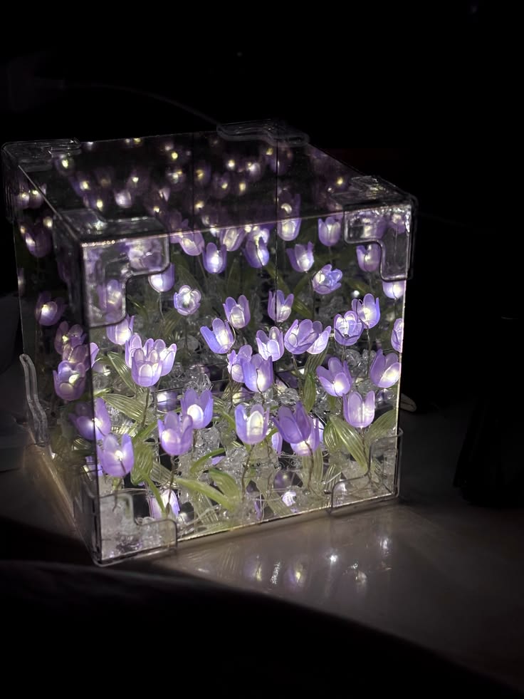 Decorative light box with purple tulip pattern on a dark background